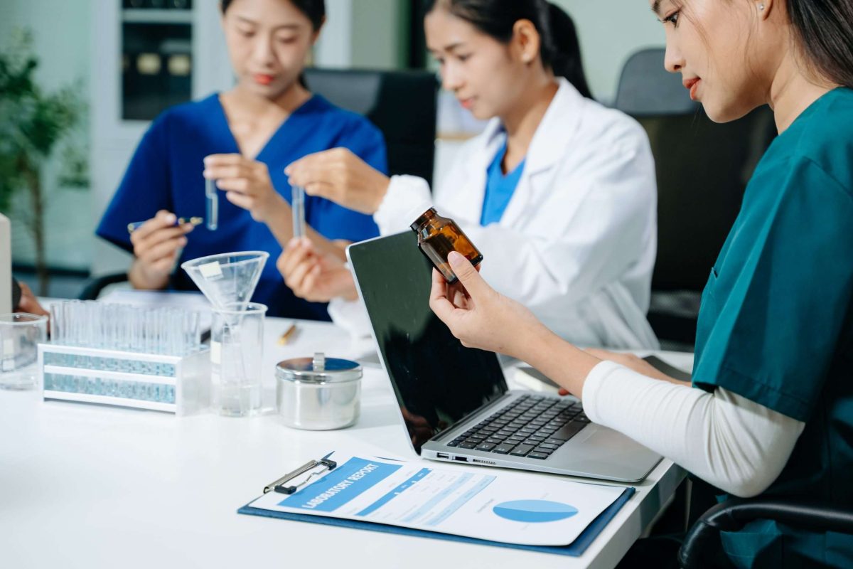 Medical technology network team meeting concept. Doctor hand working with smart phone modern digital tablet and laptop computer with graphics chart interface,
